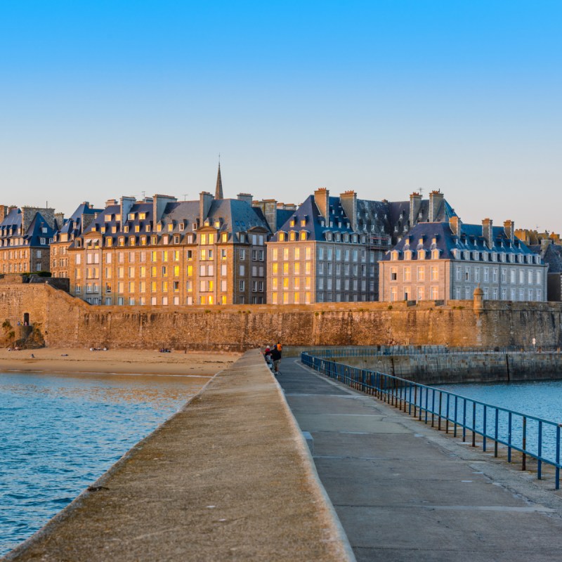 View of the fortified old town, Intra-Muros, from the Môle Des Noires pier in the evening.