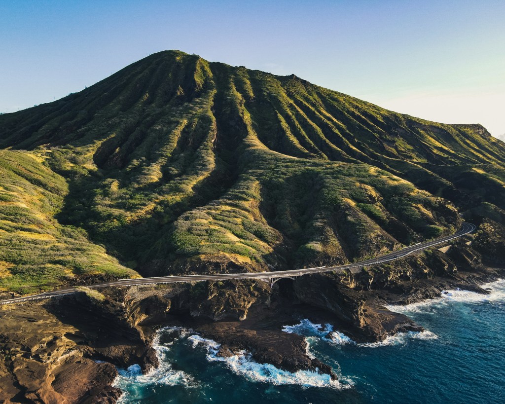 Green and brown mountain beside sea in Oahu, Hawaii