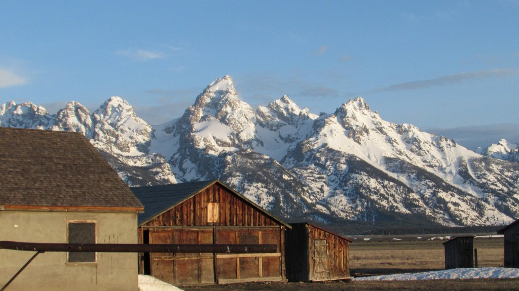 Barn sitting in front of mountain range