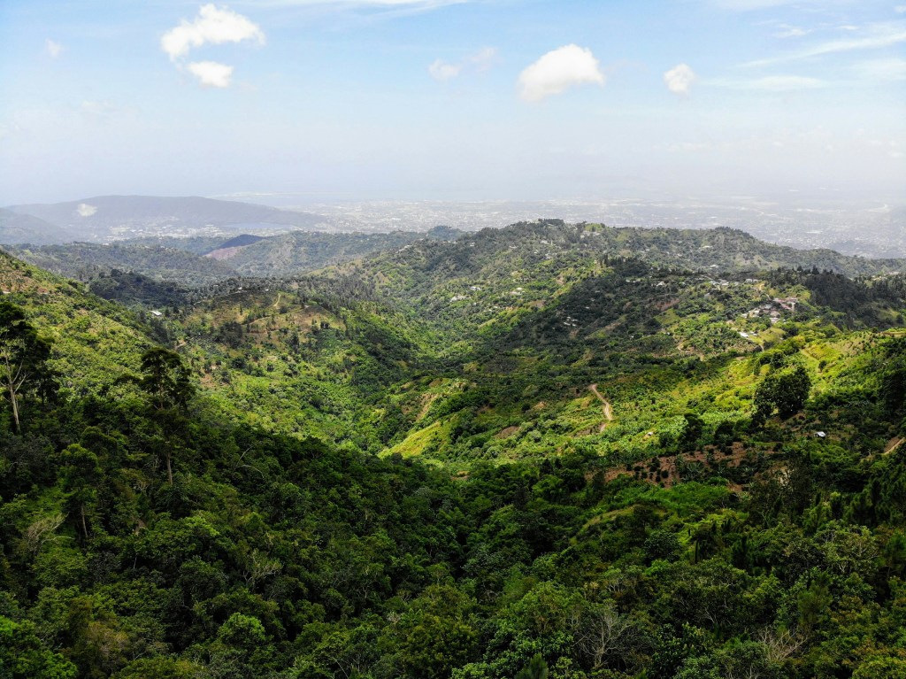 Green mountain under blue sky